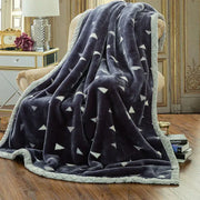 Dark gray double layered raschel blanket with white triangular patterns and light gray quilted border vintage style