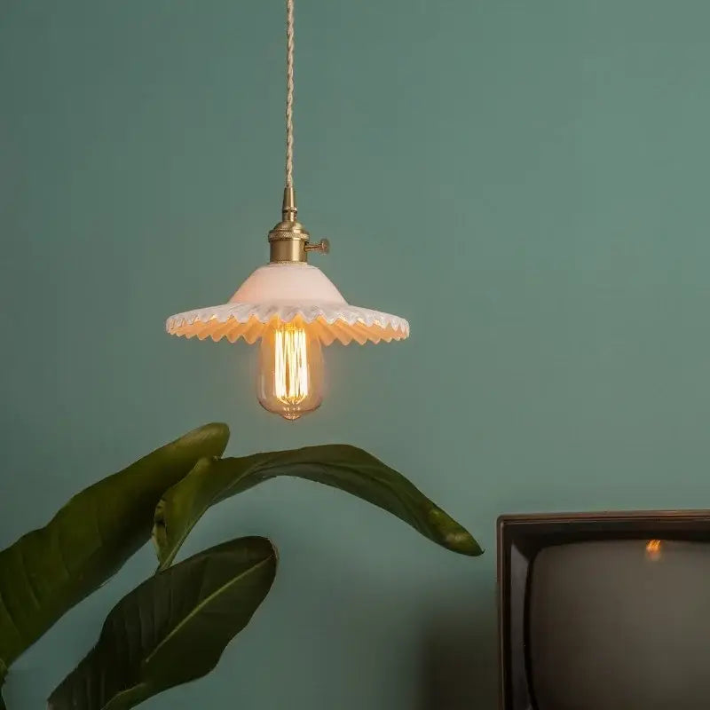 Vintage off-white ceramic pendant light with scalloped edge and brass glass led featuring exposed filament bulb