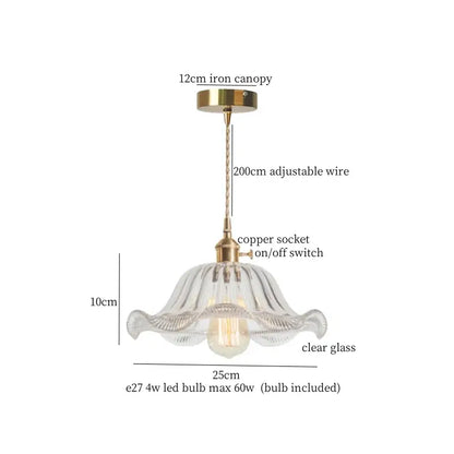 A delicate clear glass pendant light with green brass glass led components and a fluted petal design for kitchen use