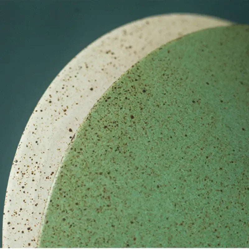 Two ceramic plates with speckled green and cream glaze complement vintage green ceramic led pendant lamp decorbites ceramic led