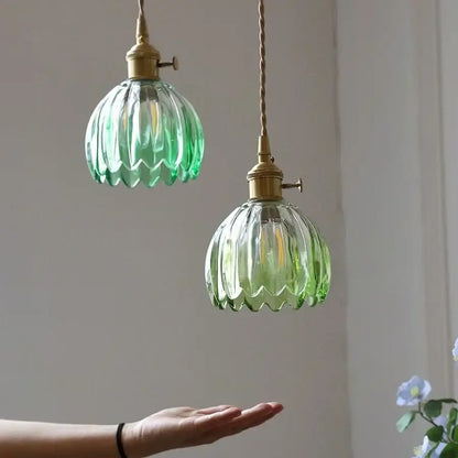 Two vintage green glass led pendant lights with brass fixtures and twisted cords for kitchen use pendant light