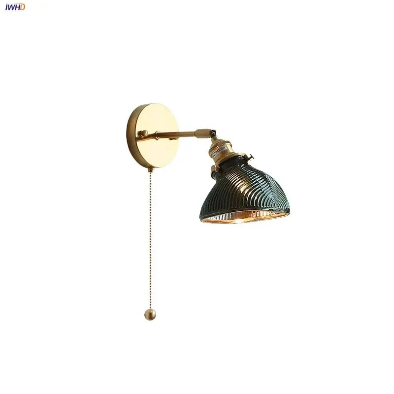 Vintage green glass led wall sconce with brass arm and amber-lined ribbed shade for bedroom or stair lighting