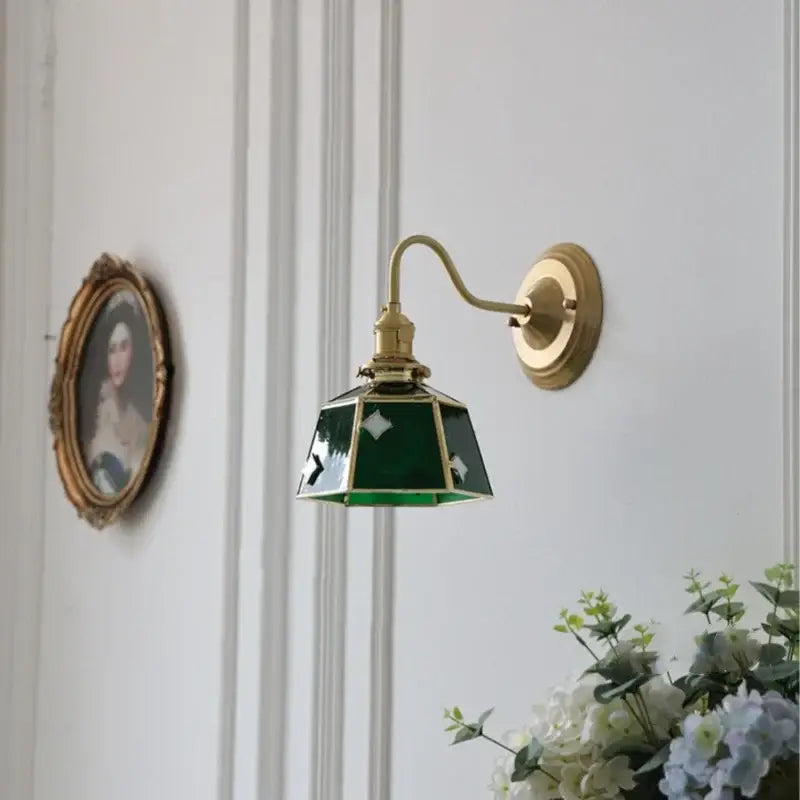 Vintage green glass led wall sconce with brass hardware and curved arm for stair lighting use