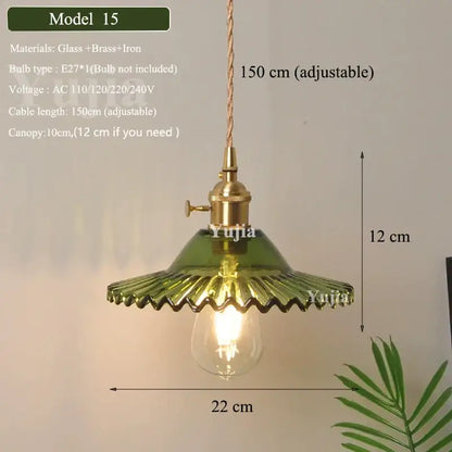 Vintage green glass pendant light with brass hardware and visible bulb featuring ruffled petal design for dining room