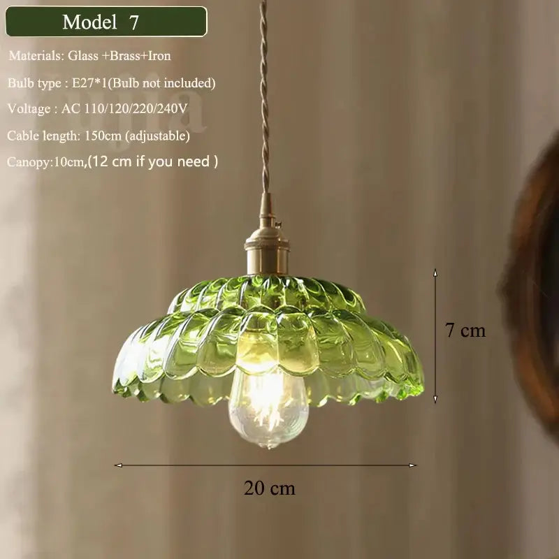 Vintage green glass pendant light with scalloped ruffled petal design, brass fixture, and twisted cord for dining room
