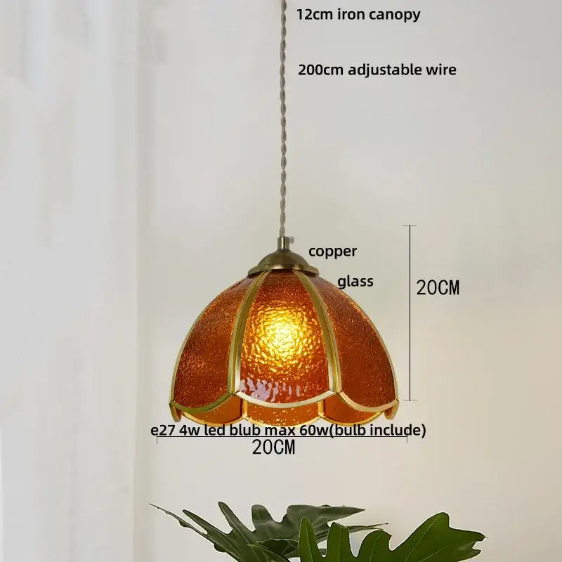 Vintage green glass pendant light with wood beads featuring a warm amber copper glass pendant light and iron canopy