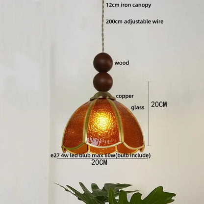 Warm amber-colored glass pendant light with copper accents and wooden beads for vintage dining room decorbites blue glass