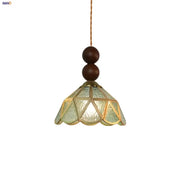 Vintage green glass pendant light with textured shade and wood beads for dining room decor featuring brass frame