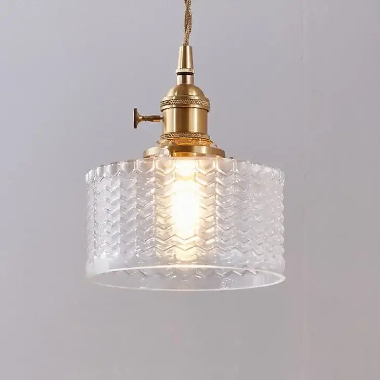 A clear glass led pendant lamp with a textured chevron pattern and brass hardware for dining room lighting