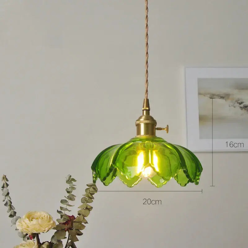 Vintage green and white glass pendant light with brass fixture and twisted cord thoughtfully styled for dining room
