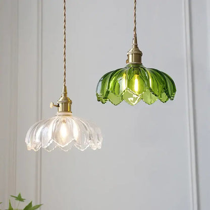 Vintage green and white glass flower pendant lights with brass fixtures and twisted cords, thoughtfully styled for dining rooms