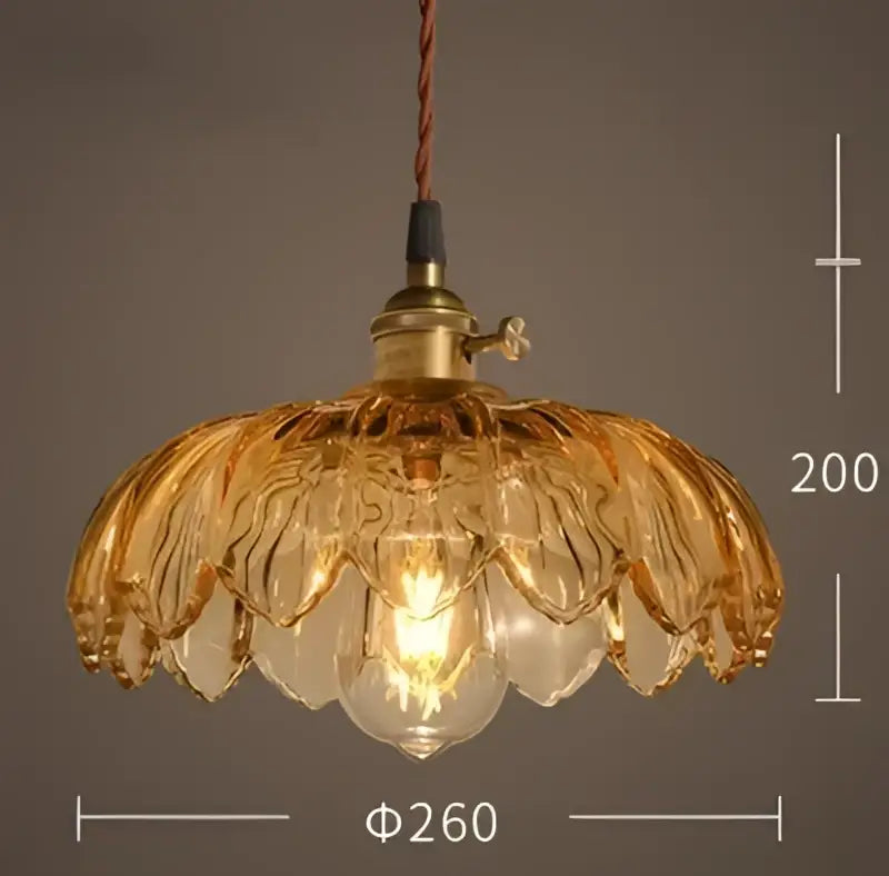 Vintage hand blown glass pendant lights with golden glass and brass fixture featuring exposed bulb for cafe lighting