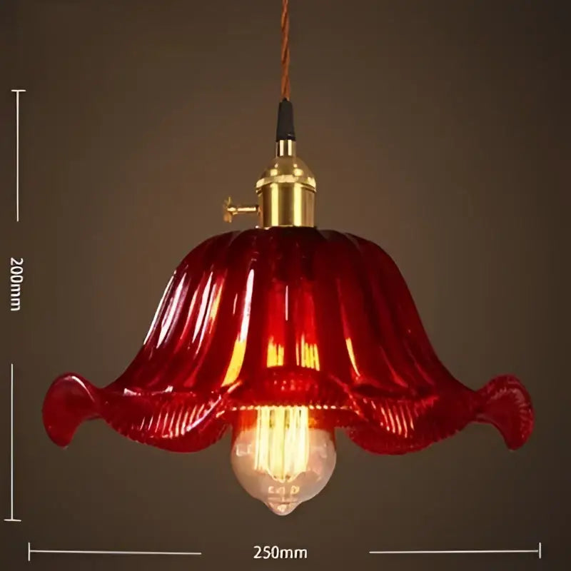 A vibrant red vintage glass pendant light with brass fixture and exposed bulb for cafe and restaurant lighting