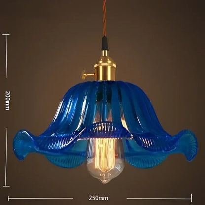 Blue glass pendant light with gold-toned metal fixture and vintage led cafe exposed filament bulb for restaurants
