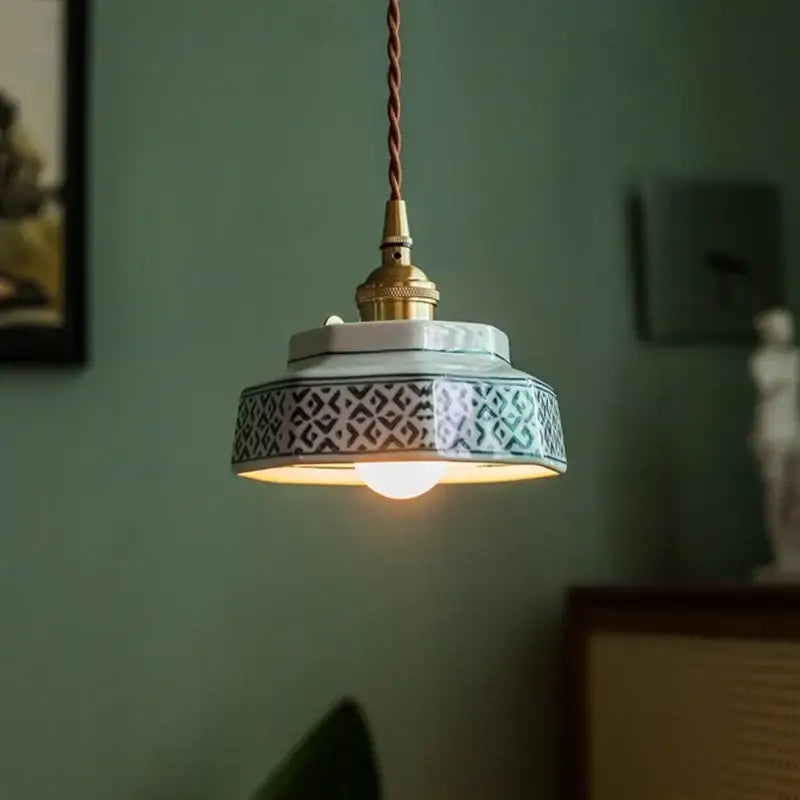 Vintage hexagonal ceramic led pendant light in red and green with a geometric black and white decorbites ceramic led pattern