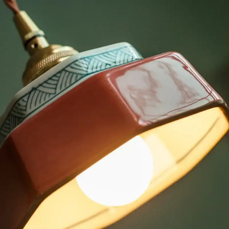 Vintage hexagonal ceramic led pendant light with red and white glaze and green geometric rim by decorbites