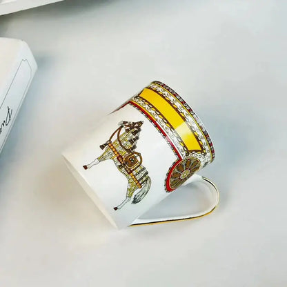White ceramic mug cup featuring vintage horse and carriage illustration in gold with ornate borders for dining room use