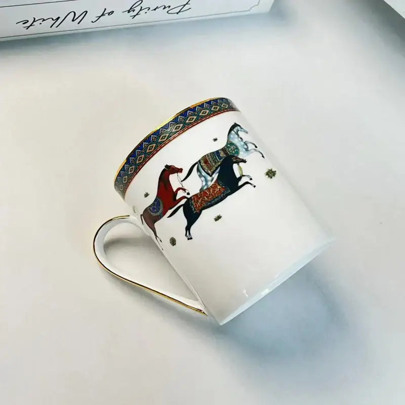 White ceramic mug cup with gold-trimmed rim and handle featuring colorful vintage horse illustration for dining room set