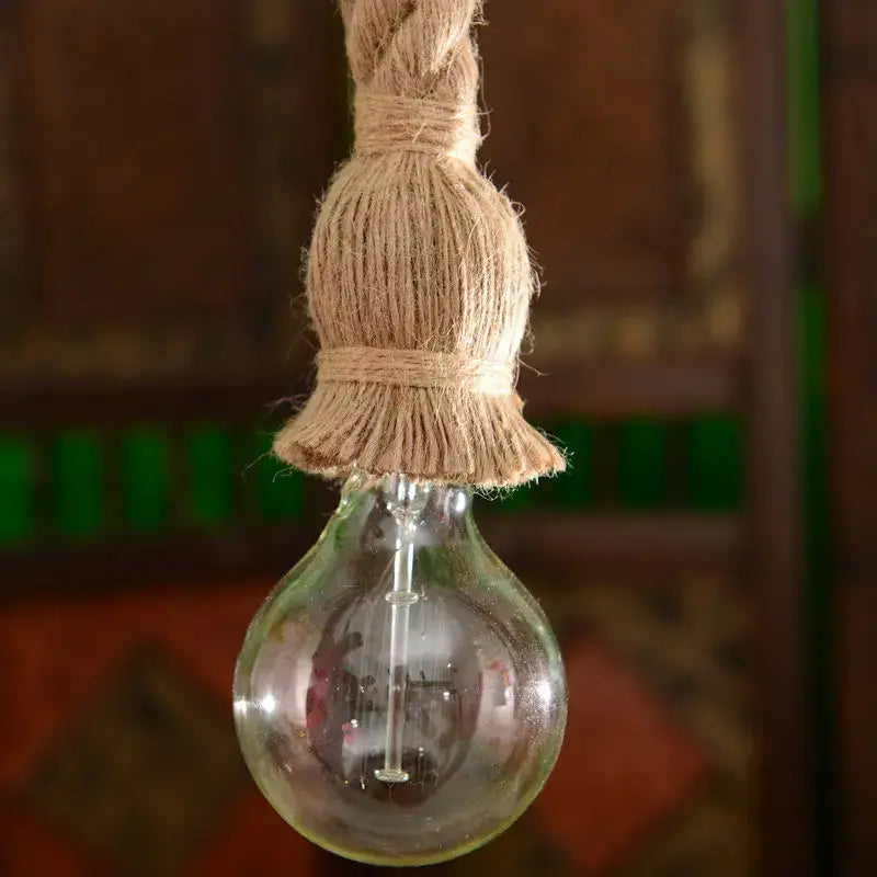 Vintage industrial beige hemp rope pendant light with a clear glass bulb and twisted jute rope for bedroom decorbites decor