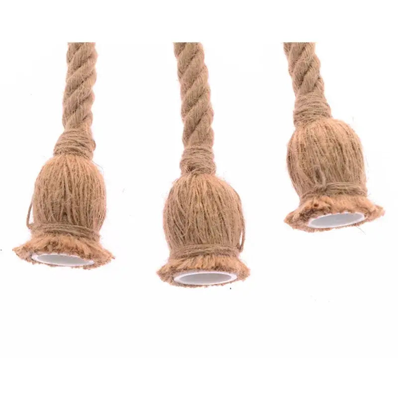Three rustic beige hemp rope pendant lights with twisted cord and bell-shaped base for vintage industrial decorbites decor
