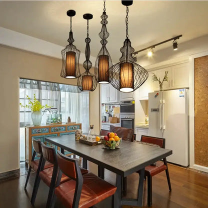 Vintage industrial black birdcage chandelier with five warm-toned cylindrical lampshades by decorbites birdcage chandelier