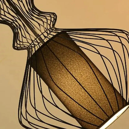 A vintage industrial black birdcage chandelier featuring a modern wireframe lampshade with a gold fabric diffuser by decorbites birdcage chandelier