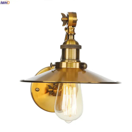 Brass-finished vintage industrial wall lamp with gold swing arm and wide dome shade featuring exposed edison bulb