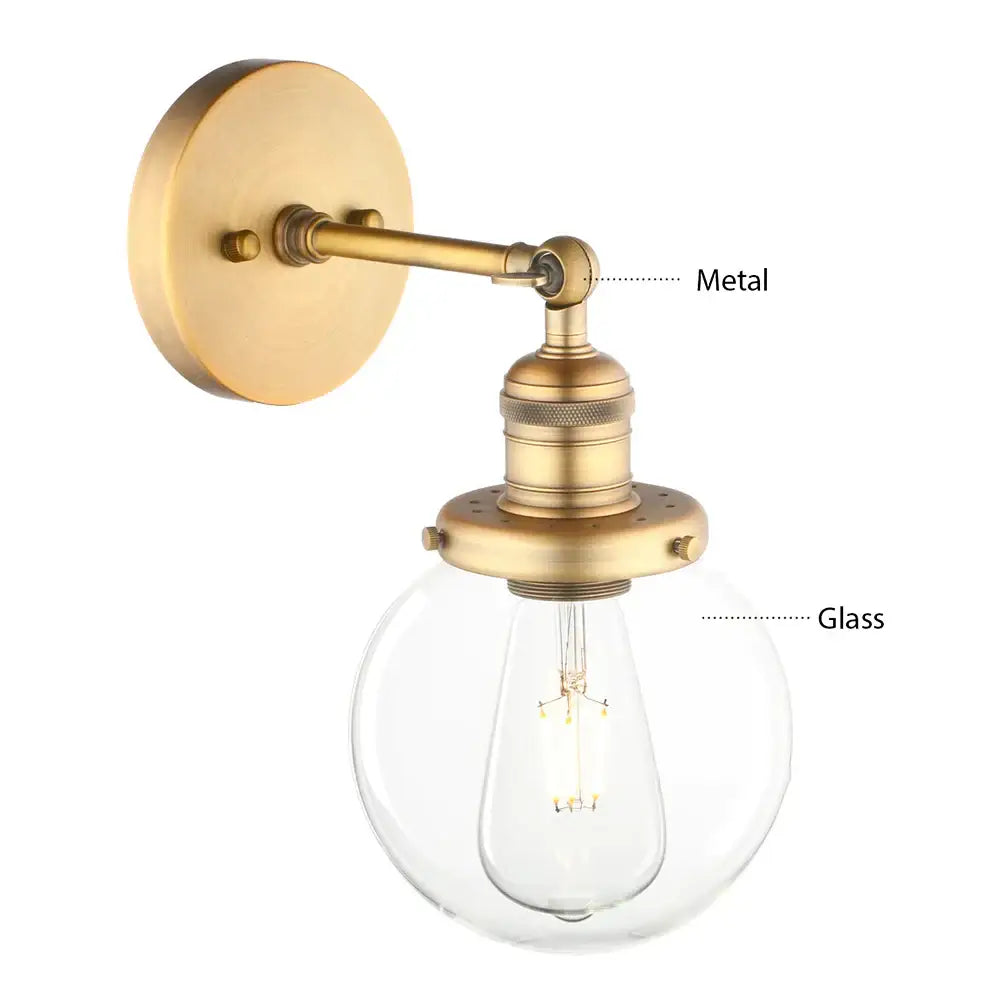 Antique brass-finished vintage industrial wall sconce with clear glass globe and exposed filament bulb for bedroom decor