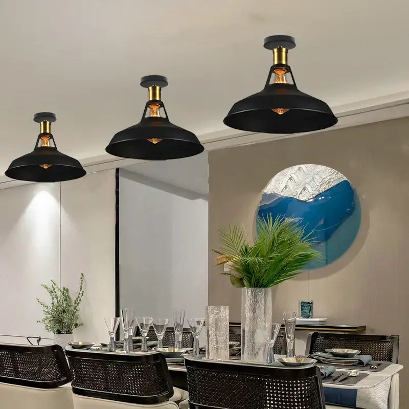Black and bronze vintage industrial flush mount light with brass accents hangs above dining table decorbites industrial flush