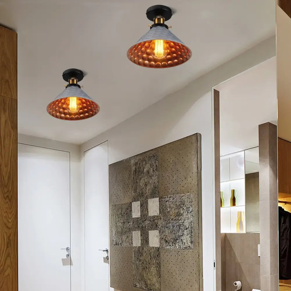 Vintage industrial flush mount light featuring copper-hued hammered metal pendant with brass accents and filament bulbs