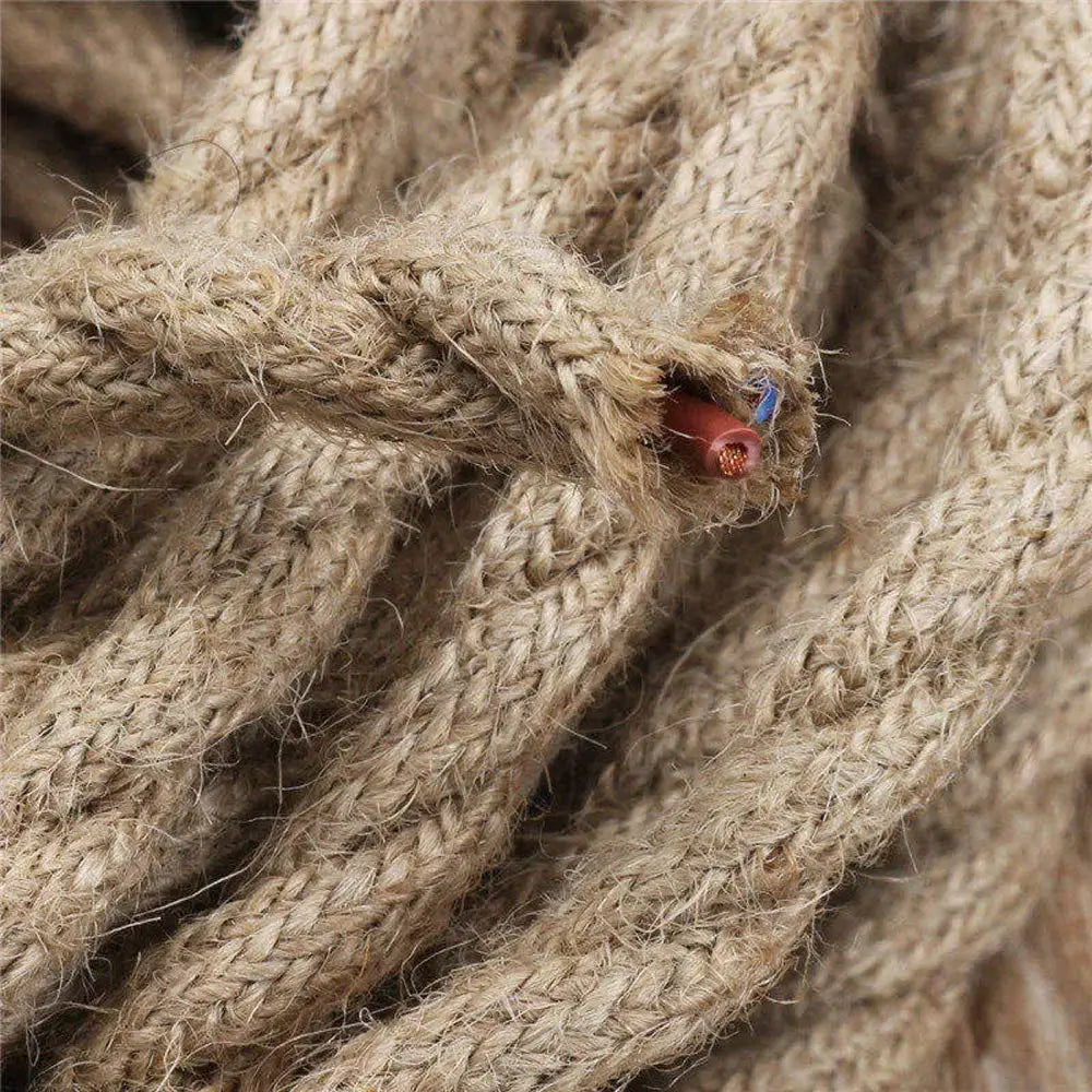 Coarse beige hemp rope with frayed end showing red and blue woven textile wire for living room cord use