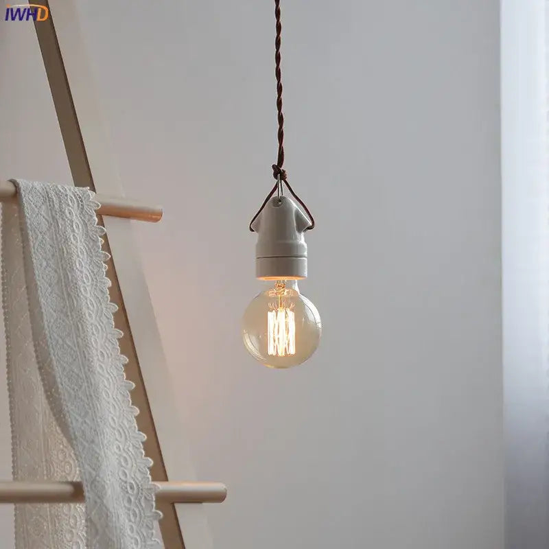 A warm-toned vintage industrial matte white ceramic led pendant lamp with decorbites ceramic led bulb hanging from twisted cord