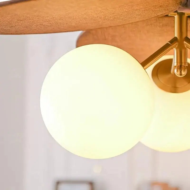 Vintage layered wood petal pendant light with warm-toned frosted glass globe and brass hardware for dining room