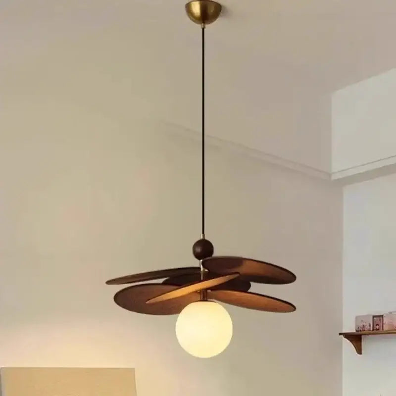 A vintage layered wood petal pendant light with brass accent and frosted glass globe for dining room lighting
