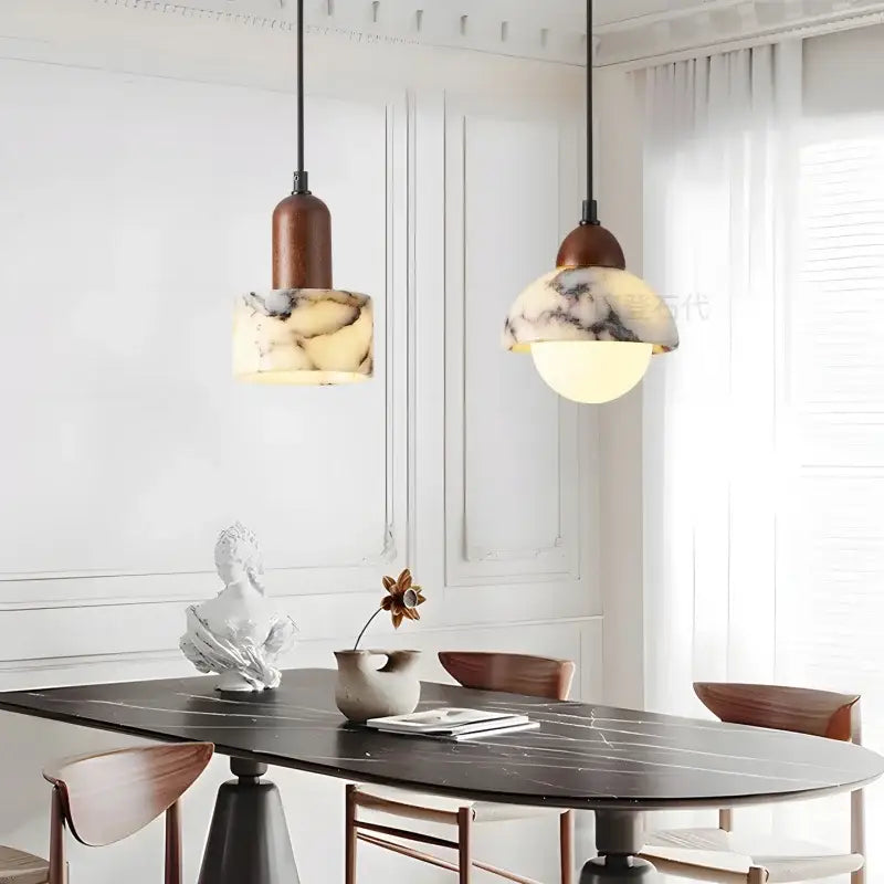 Two warm-toned vintage marbled glass ball led pendant lights with dark brown tops hang over a dining table decorbites glass ball