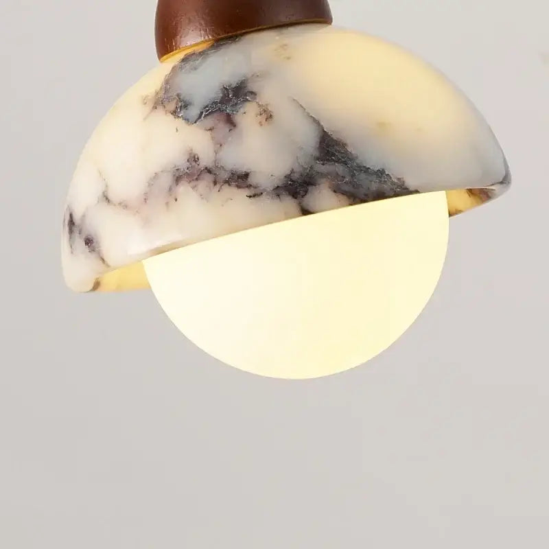Vintage marbled glass ball led pendant light with creamy white and dark gray stone shade accented by gold trim