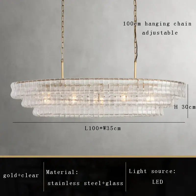 A modern tiered decorbites brown glass chandelier with clear glass mosaic panels and gold stainless steel accents for dining room