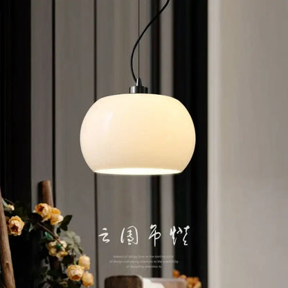 Cream-colored vintage nordic ceramic pendant lights with glossy finish and black cord for dining room or restaurant use
