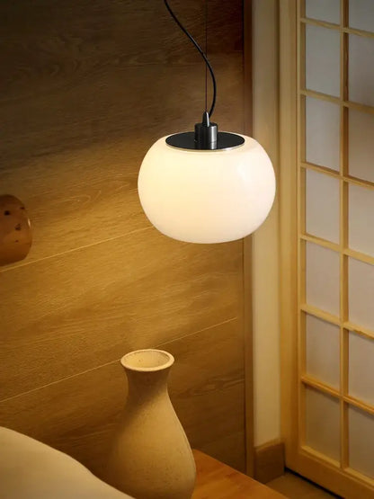 A vintage nordic cream ceramic pendant light with frosted glass and black metal fixture for dining room or kitchen