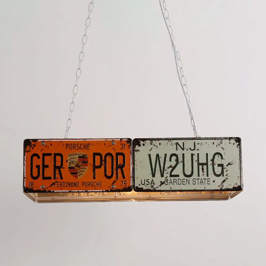 Vintage orange and white license plate rectangle island ceiling light with Porsche branding hanging by silver chains