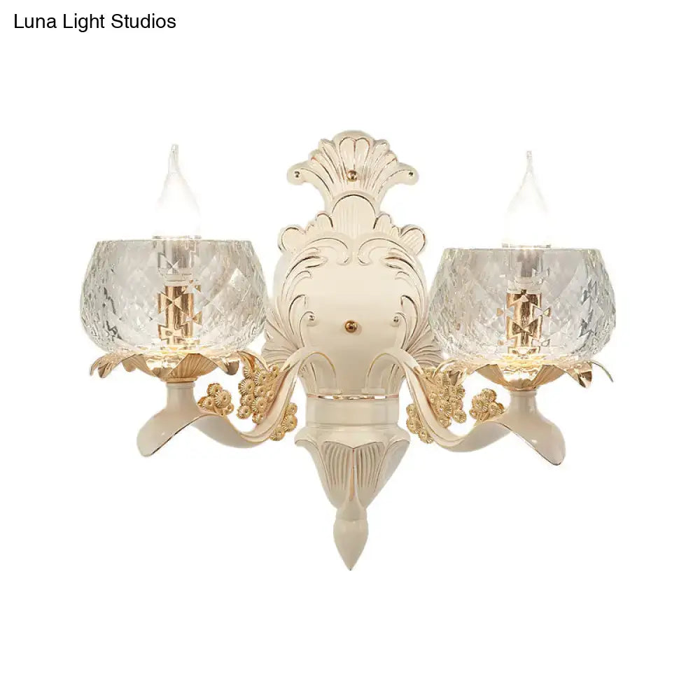 Elegant vintage ornate cream and gold wall light sconce with two faceted crystal glass shades for bedroom