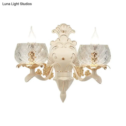 Elegant vintage ornate cream and gold wall light sconce with two faceted crystal glass shades for bedroom
