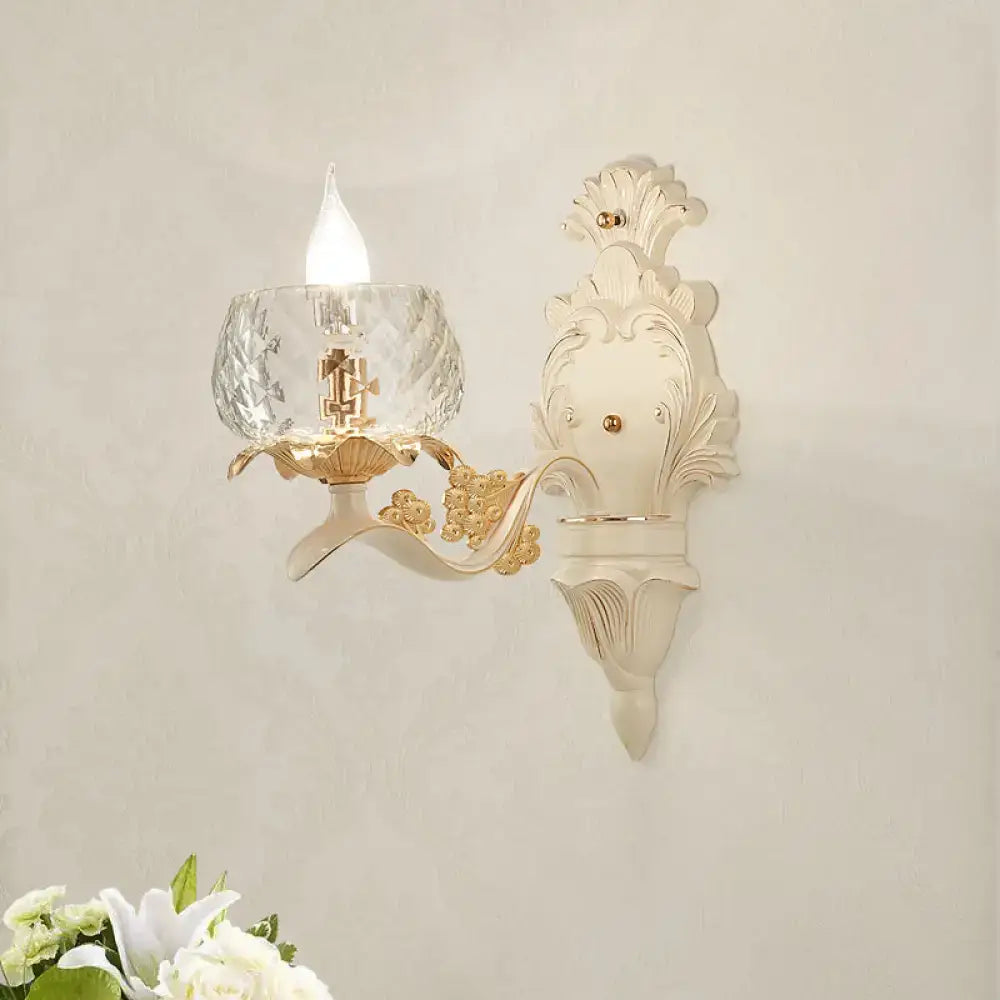 Elegant vintage ornate cream and gold wall light sconce with faceted crystal glass shade for bedroom lighting