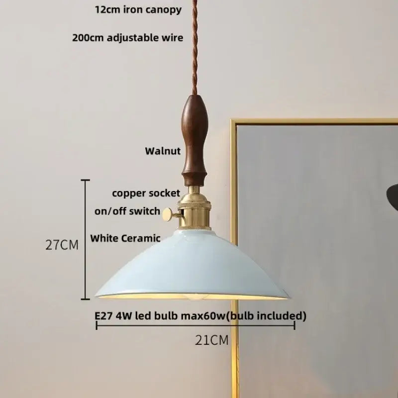 Vintage pale blue enamel pendant light with ceramic knob switch featuring white ceramic shade brass accents and walnut canopy