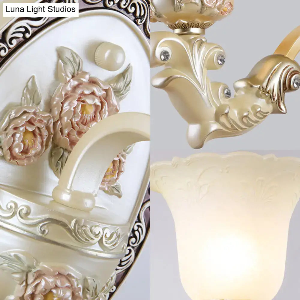 Cream-colored vintage petal glass wall sconce with floral scrollwork and frosted shade for 110v-120v living rooms