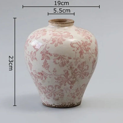A white ceramic vintage pink floral vase with cracked texture and slightly chipped earthy brown rim for decorbites decor