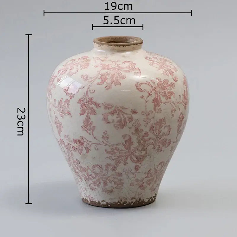 A white ceramic vintage pink floral vase with cracked texture and slightly chipped earthy brown rim for decorbites decor