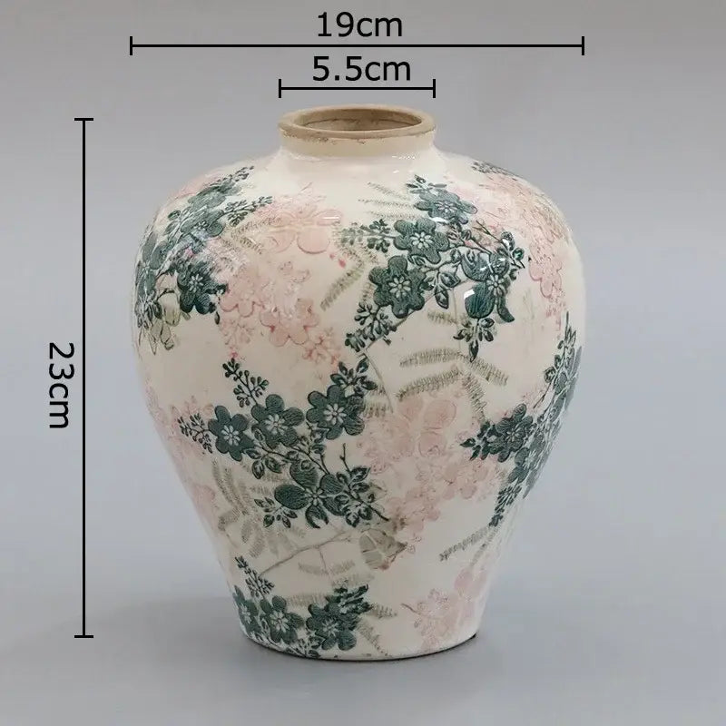 A cream-colored ceramic vintage vase with cracked texture and delicate pink floral decorbites cracked texture decor