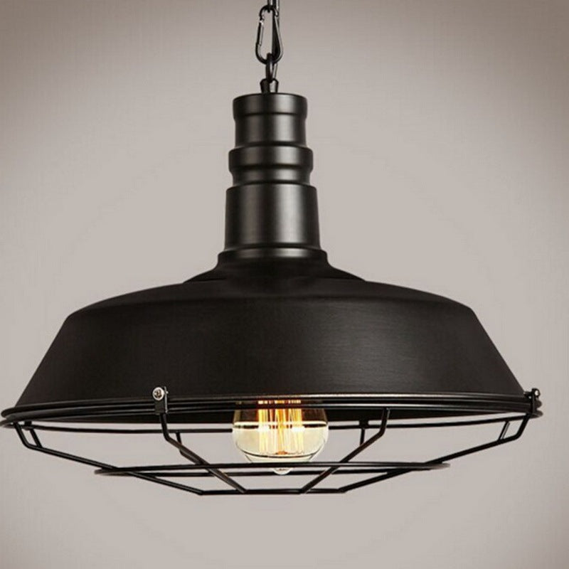 Black industrial cage pendant light with exposed bulb and metal frame.