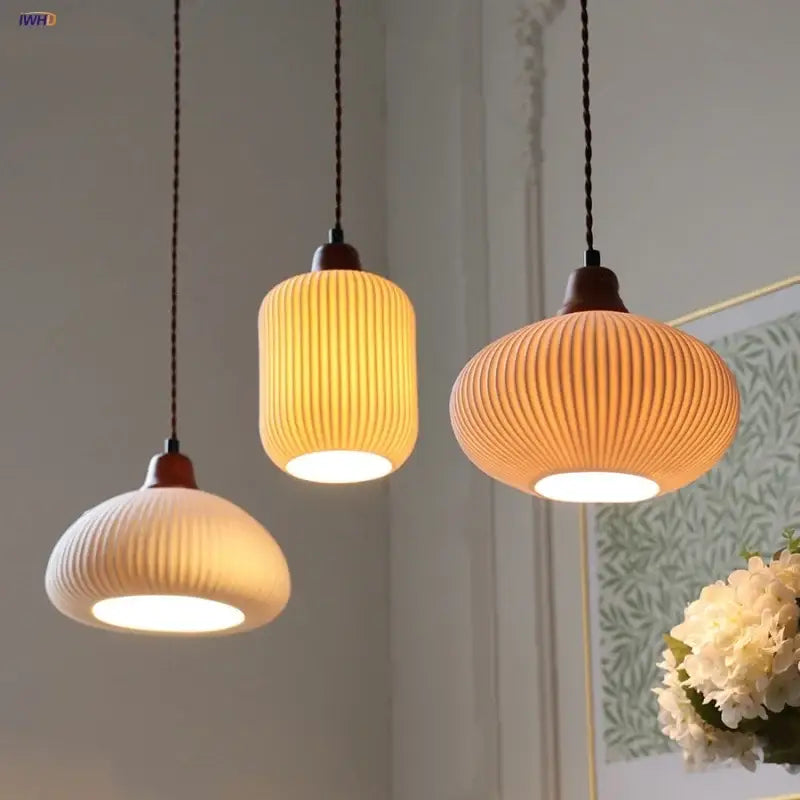 Three warm-toned vintage ribbed ceramic wood led pendant lights with dark wooden fixtures for dining room decorbites